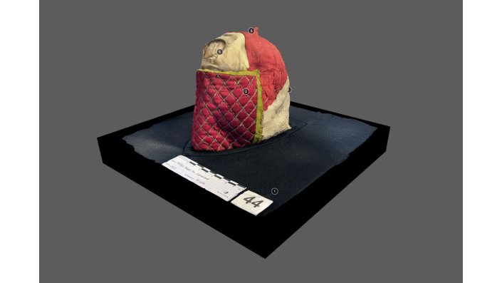 3D-Scan des mit rotem Stoff umhüllten Reliquienschädels.